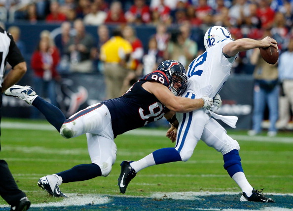 HOUSTON, TX - DECEMBER 16:  Andrew Luck #12 of the Indianapolis Colts is sacked by J.J. Watt #99 of the Houston Texans in the first half of during the game  at Reliant Stadium on December 16, 2012 in Houston, Texas.  (Photo by Scott Halleran/Getty Images)