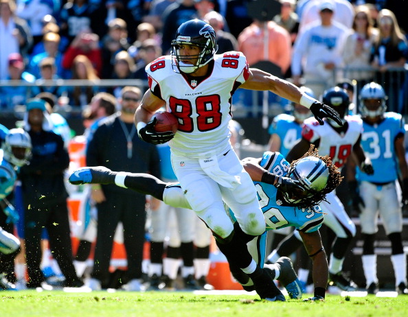 CHARLOTTE, NC - NOVEMBER 03:  Tony Gonzalez #88 of the Atlanta Falcons makes a catch as Robert Lester #38 of the Carolina Panthers defends during play at Bank of America Stadium on November 3, 2013 in Charlotte, North Carolina.  (Photo by Grant Halverson/Getty Images)
