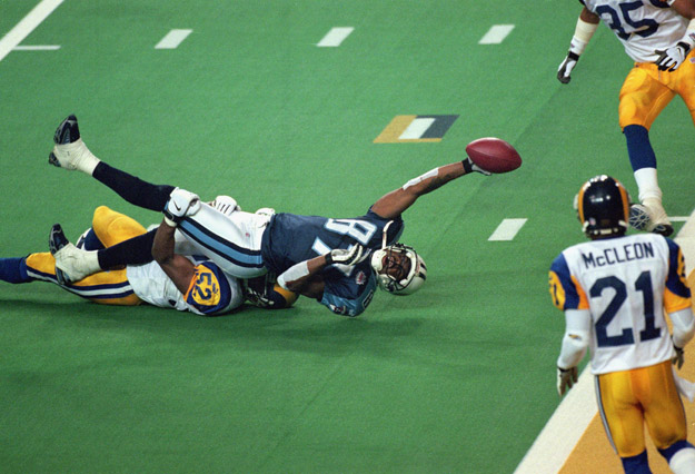 ATLANTA - JANUARY 30:  Kevin Dyson #87 of the Tennessee Titans reaches for the end zone with the ball as Mike Jones #52 of the St. Louis Rams tackles him on the last play of the game during the Super Bowl XXXIV Game at the Georgia Dome on January 30, 2000 in Atlanta, Georgia. The Rams defeated the Titans 23-16. 