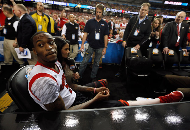 ATLANTA, GA - APRIL 06:  Injured Louisville Cardinals player Kevin Ware #5 sits on the bench as he waits to be interviewed by CBS Sports reporter Tracy Wolfson before the Cardinals take on the Wichita State Shockers in the 2013 NCAA Men's Final Four Semifinal at the Georgia Dome on April 6, 2013 in Atlanta, Georgia.  