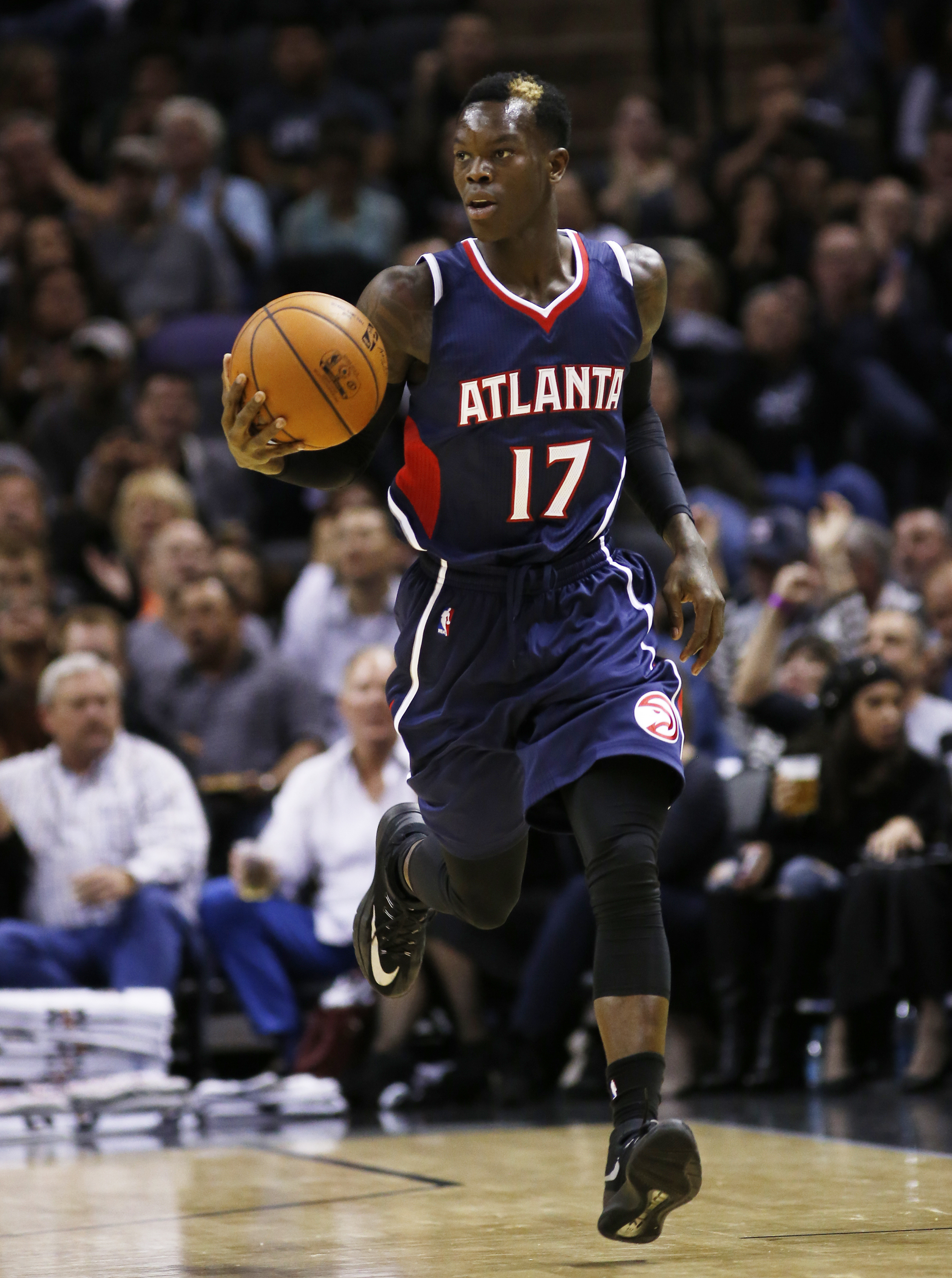 SAN ANTONIO, TX - NOVEMBER 5: Dennis Schroder #17 of the Atlanta Hawks brings the ball up court against the San Antonio Spurs at the AT&T Center on November 5, 2014 in San Antonio, Texas. NOTE TO USER: User expressly acknowledges and agrees that, by downloading to the terms and conditions of the Getty Images License Agreement. (Photo by Chris Covatta/Getty Images)