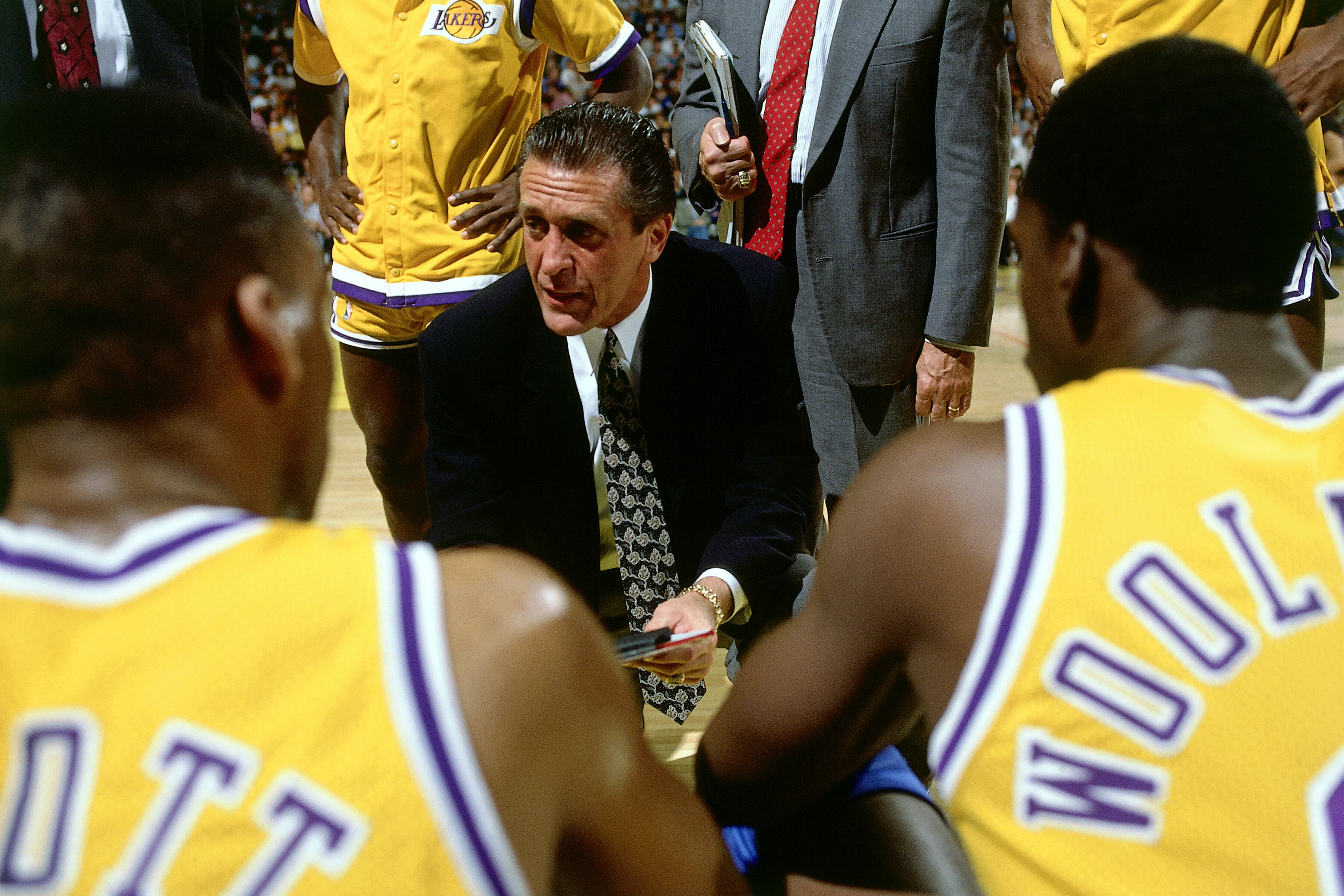 LOS ANGELES -1989: Head Coach Pat Riley of the Los Angeles Lakers goes over a few plays during a time out in an NBA game circa 1989 in Los Angeles, California. NOTE TO USER: User expressly acknowledges and agrees that, by downloading and/or using this Photograph, user is consenting to the terms and conditions of the Getty Images License Agreement. Mandatory Copyright Notice: Copyright 1989 NBAE (Photo by Andrew D. Bernstein/NBAE via Getty Images)