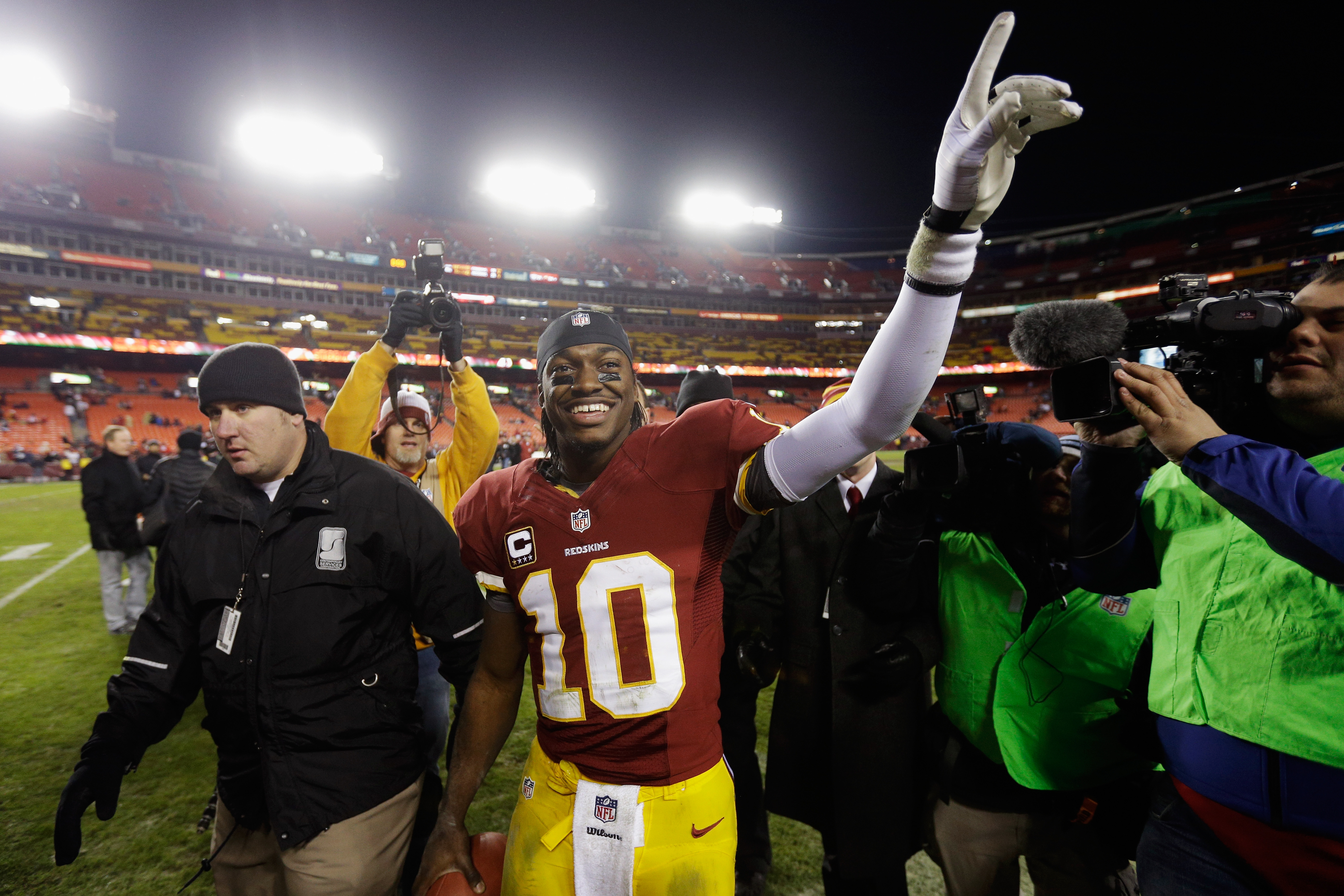 Quarterback Robert Griffin III celebrates after the Redskins defeated the Dallas Cowboys to win the NFC East in 2012. (Photo by Rob Carr/Getty Images)